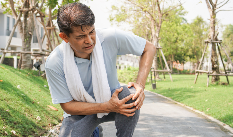 Asian senior man falling down and getting knee hurt Asian senior man falling down and getting knee hurt from walking or jogging exercise at the park. pain and injury for elderly insurance concept